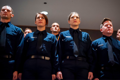 recruits lined up at ceremony in blue uniforms