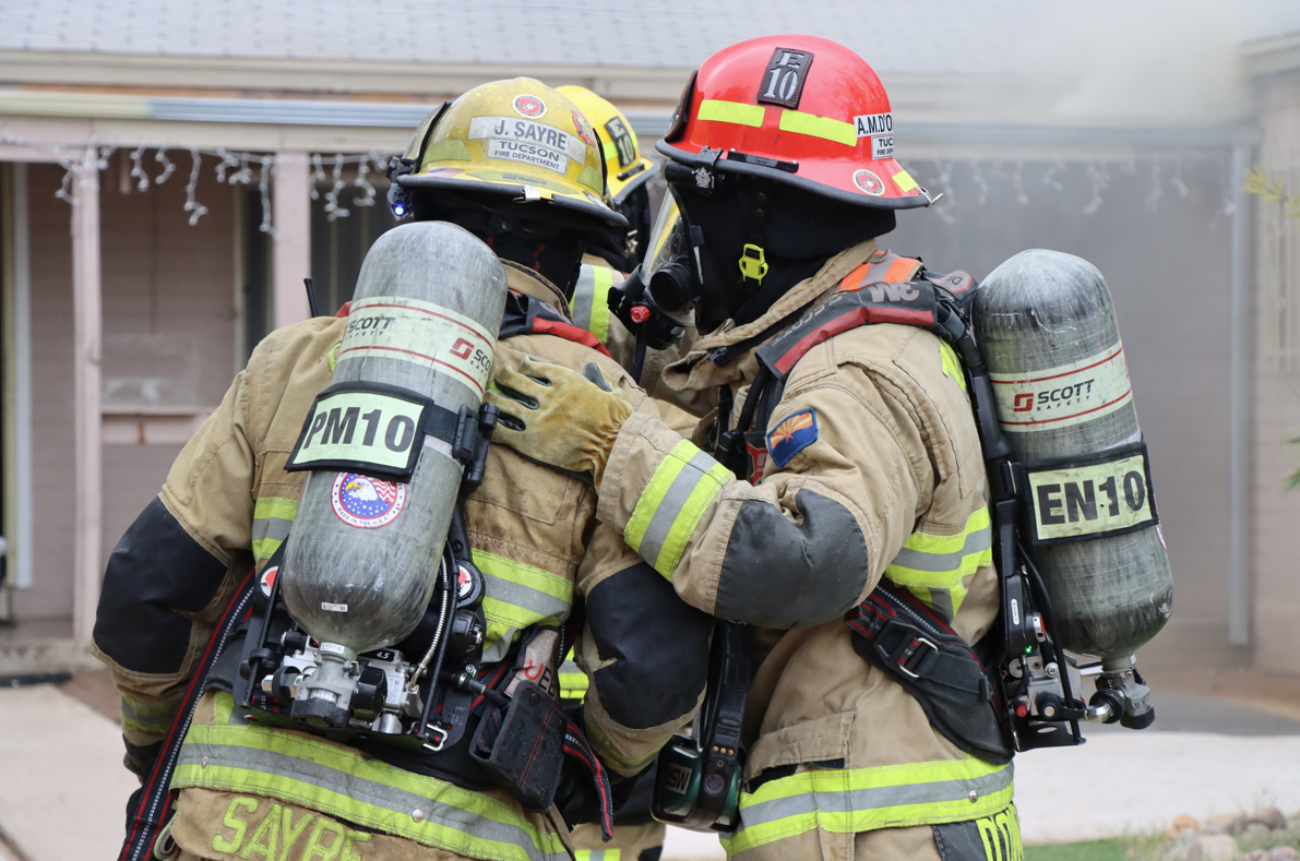 two fire fighters standing